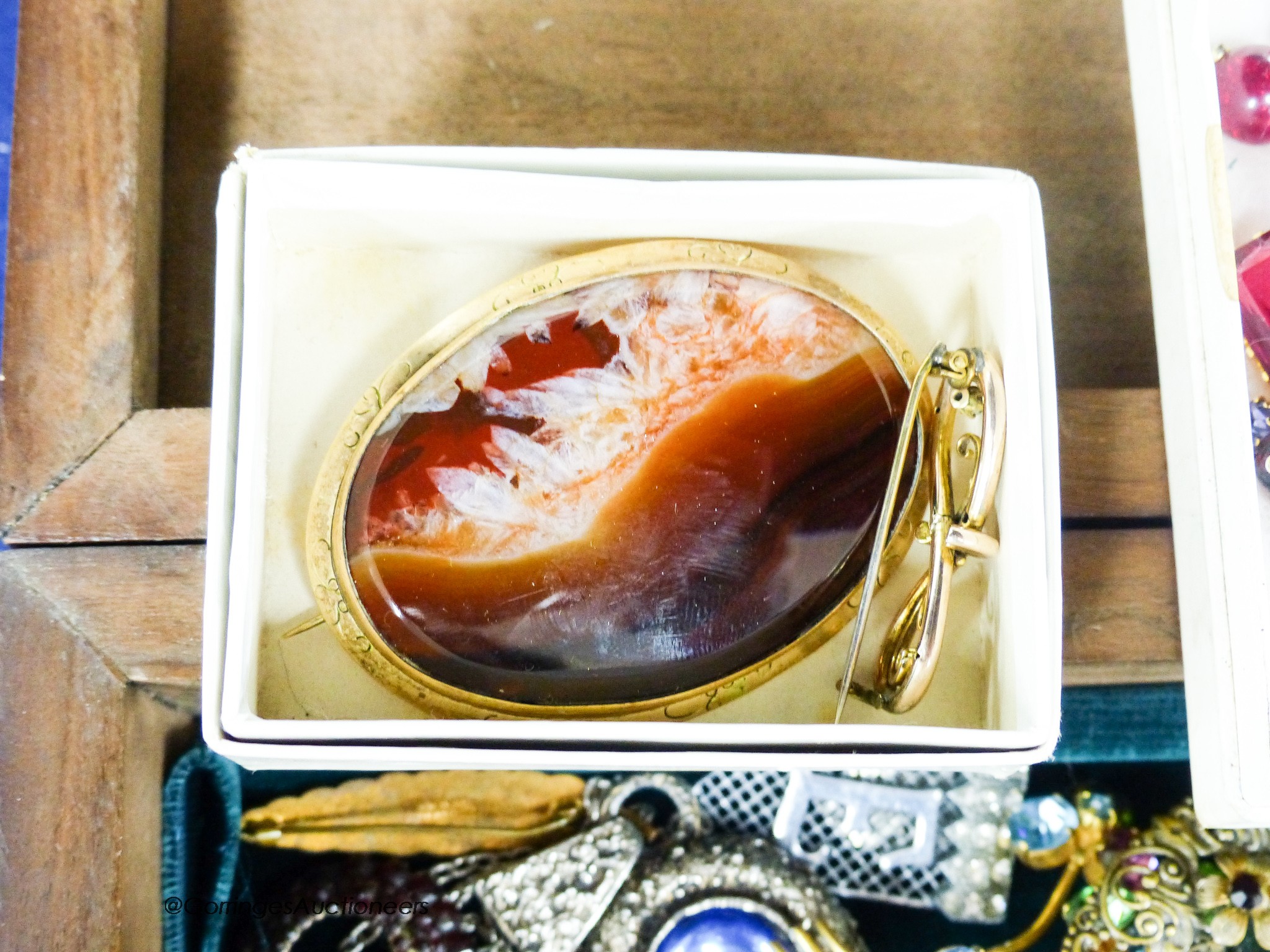 A yellow metal mounted agate oval brooch, 67mm, a 9ct and gem set brooch, 39mm, gross 3.1 grams and a quantity of assorted costume jewellery.